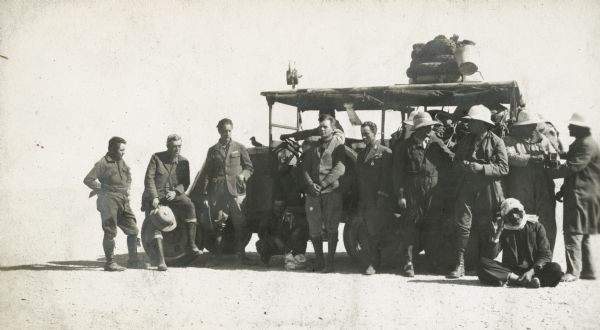 De Prorok's car, Sandy and all members of the expedition: Pond, Tyrrell, De Prorok, Martini, Denny, Reygasse, Chauffeur Barth, Chapuis, Belaid, and in front, Squatty the cook.