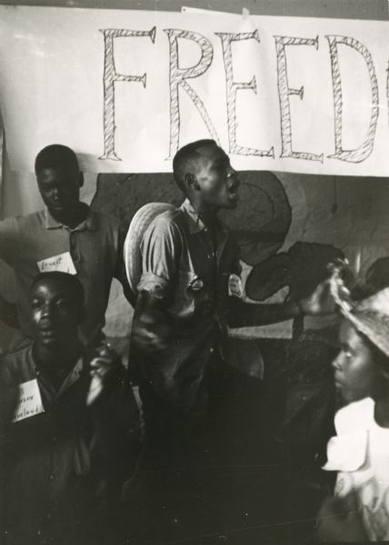 A group sings freedom songs at the Freedom School Convention during Freedom Summer.