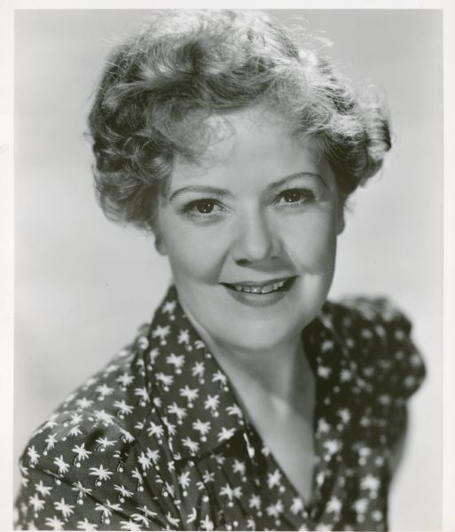 Publicity still of actress Spring Byington in a black shirt with white flower print.