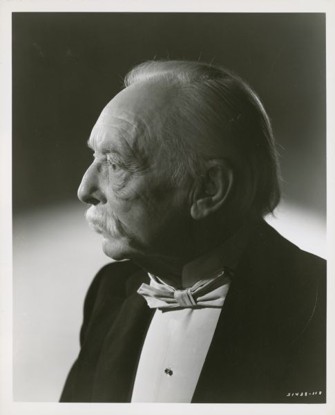 Publicity still of actor Harry Davenport. Caption reads: Veteran...of motion pictures, each role more distinguished than its predecessor, Harry Davenport gives an outstanding performance in Metro-Goldwyn-Mayer's "The Forsyte Saga," as 'Old Joly,' domineering head of the fabulous family. Technicolor film has an all-star cast headed by Greer Garson, Errol Flynn, Walter Pidgeon, Robert Young and Janet Leigh. Compton Bennett directed, Leon Gordon producing.