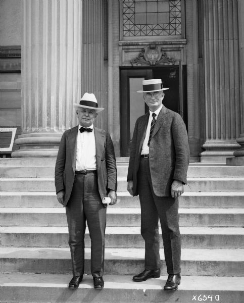 Richard T. Ely and Henry C. Taylor stand together on the front steps of Agriculture Hall at the University of Wisconsin in Madison.