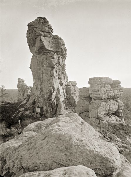 Rock formations along the top of Fort Rider. The photographer's wet negative plate equipment is at foot of the rock formation.