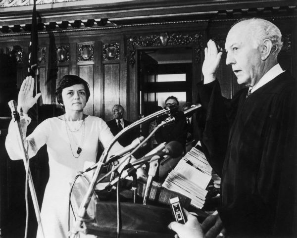 Shirley Abrahamson, the first woman to be appointed as a Justice of the Wisconsin State Supreme Court, takes her oath. Chief Justice Bruce Beilfuss is on the right.