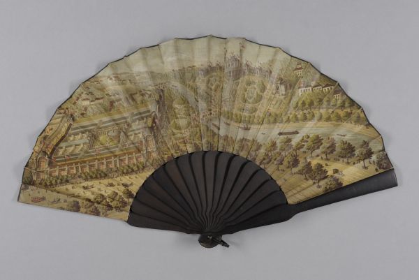 A handheld fan made of wood and cloth. This fan depicts the event it was made to commemorate — the 1878 Exposition Universelle held in Paris, France. The fan belonged to Elizabeth Smith (Jacques) Upham (1815-1888) of Milwaukee, Wisconsin. Born in Wilmington, Delaware, Elizabeth had moved to Milwaukee in 1838 with her husband, attorney Don Alonzo Joshua Upham. Mrs. Upham probably did not attend the Exposition in Paris, and this fan may have been a gift to her.