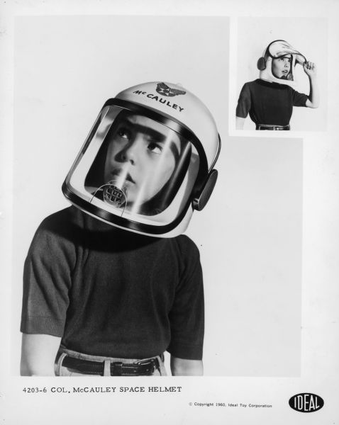 A young man models the Colonel McCauley space helmet based on the television show <i>Men Into Space</i>.
