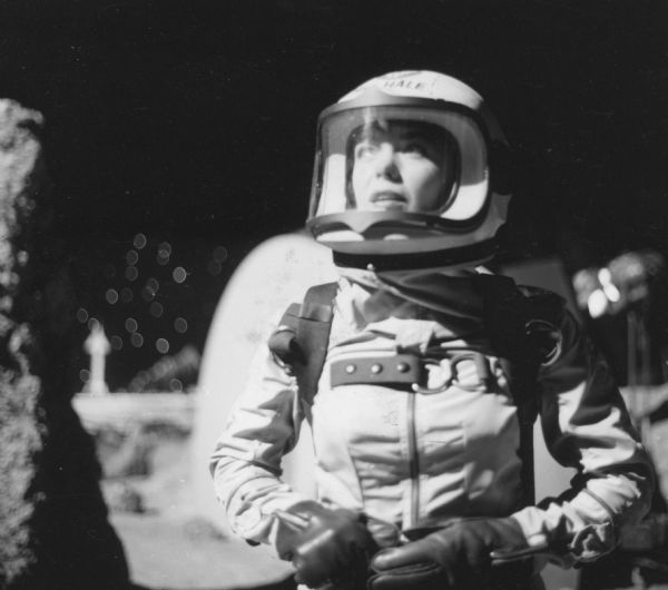 Nancy Gates, who plays Renza Hale on an episode of the television show <i>Men Into Space</i>, is shown in a spacesuit and helmet on the lunar landscape set of the show.