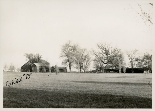 The Elmer Willis Sesl (sp?) farm. The photograph has the term "Exhibit "B"" written on the front in ink.