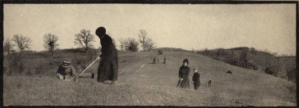 People playing golf in the fields at Hillside Home School, an early progressive school operated by Ellen and Jane Lloyd Jones, aunts of Frank Lloyd Wright.