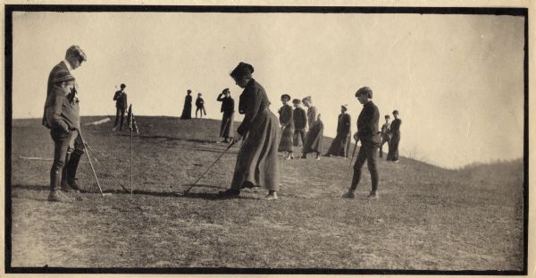 People playing golf outside of Hillside Home School, an early progressive school operated by Ellen and Jane Lloyd Jones, aunts of Frank Lloyd Wright.