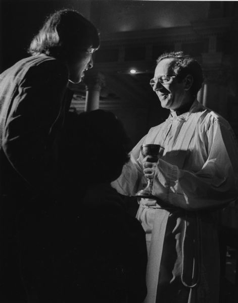 Father James Groppi serving Communion to a couple at St. Michael's Church.