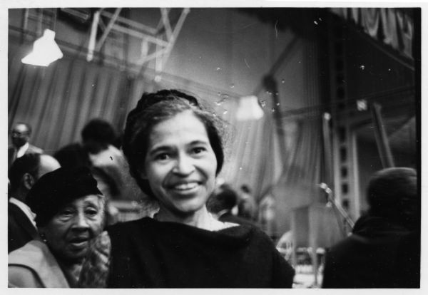 Informal portrait of Rosa Parks at a event.