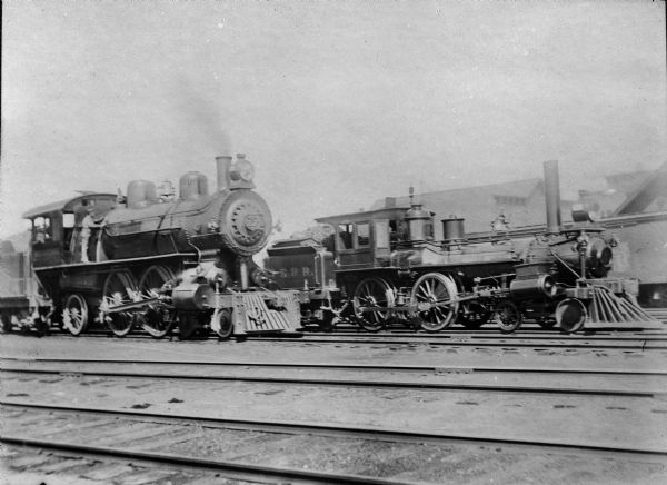 Wisconsin Central locomotive no. 257 (left) and Abbotsford and Northeastern Railroad locomotive No.1. The engineer is Lew Choate and the fireman is Ole "Jim" Hanson.