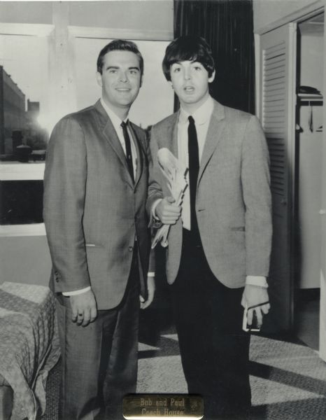 "Beatle" Bob Barry, disc jockey for Milwaukee radio station WOKY, posed for a photograph with (Sir) Paul McCartney. At the bottom is a brass plate that reads: "Bob and Paul Coach House."