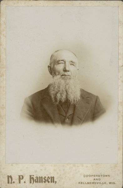 Quarter-length vignetted studio portrait of Fritz William Rasmussen.