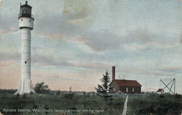 Hand-colored postcard showing the lighthouse and fog signal at Devil's Island in the Apostle Islands. Caption reads: "Apostle Islands, Wis. Devil's Island, Lighthouse and fog signal."