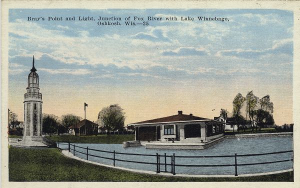 Hand-colored postcard view of the lighthouse and boathouse at Bray's Point. Caption reads: "Bray's Point and Light, Junction of Fox River with Lake Winnebago, Oshkosh, Wis."