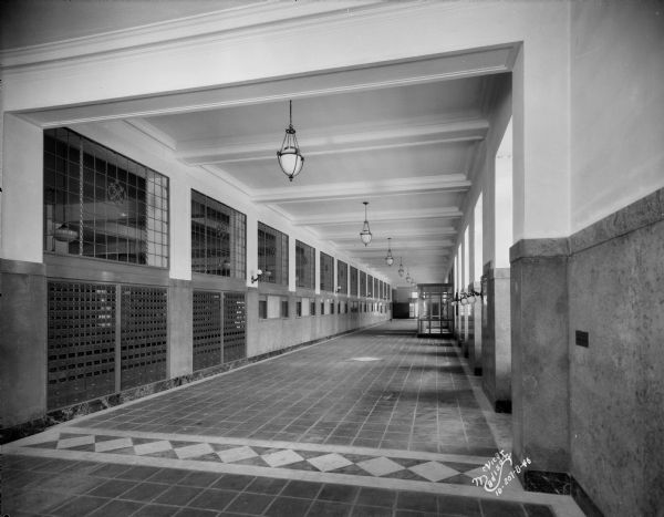 Completed first floor lobby looking toward Wilson Street entrance, with mail boxes, tile floor and light fixtures in place.