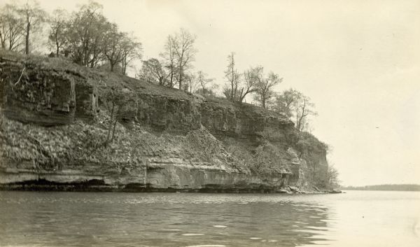 A view from the west of Maple Bluff. Part of the roof of a cottage can be seen above the bluff.