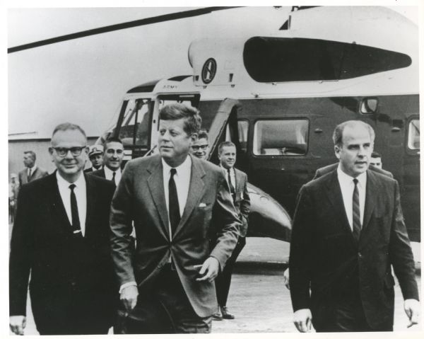 Gaylord Nelson, John F. Kennedy, and John Reynolds on the 1963 tour of the Apostle Islands. There is a U.S. Army helicopter in the background.