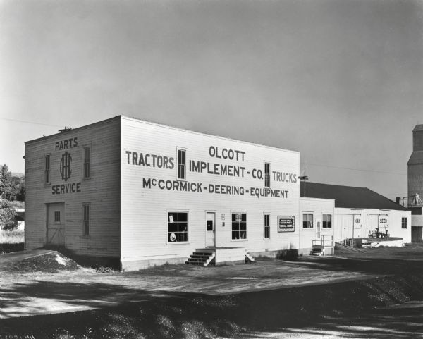Exterior of the Olcott Implement Company, an International Harvester dealership.