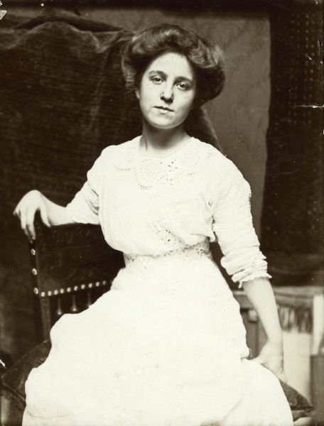 A seated portrait of Sigrid Schultz wearing a white dress.