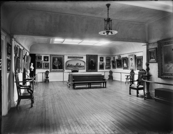 Gallery 405 in the museum of the State Historical Society. Interior showing paintings on the walls, and a skylight in the ceiling.