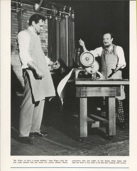Actors portraying I.M. Singer and his friend George Zieber with the first sewing machine.