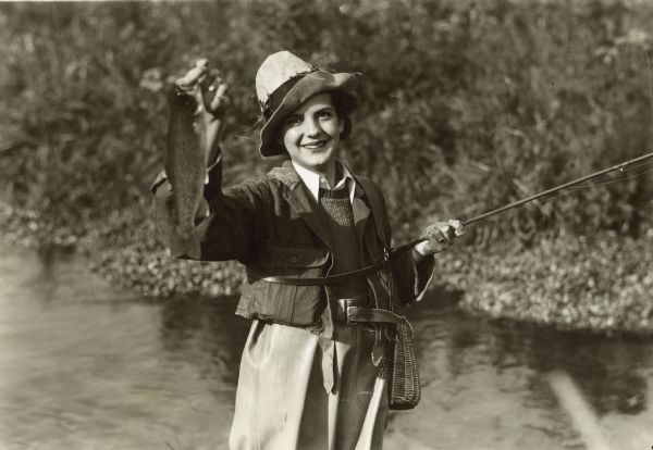 Woman Holding Trout and Fly-Fishing Rod, Photograph