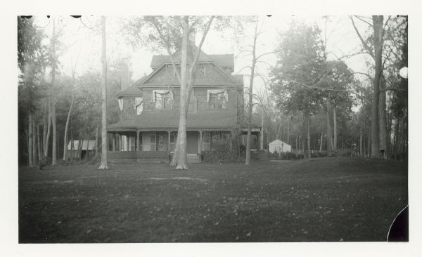 View of the E.M. Fuller property (52 acres) and house, at 16 Fuller Court. The house was built by E.M. Fuller on the shores of Lake Mendota at 16 Fuller Court in Fuller's Woods, Maple Bluff. E.M. Fuller was a prominent lumberman who built the Fuller Opera House on E. Mifflin Street in Madison. Louis and Shirley Fuller Hobbins, and their only daughter, Shirley, moved into the house after the deaths of Mr. and Mrs. Fuller. It was torn down in 1965.
