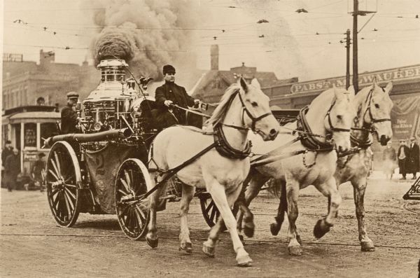 A steam fire engine of Milwaukee's Fire Company #2 drawn by three white horses racing to a fire. Prior motor driven fire equipment was a greater danger than it was during the twentieth century. Even with the best horses and equipment, fire fighters often arrived too late to save a burning building.