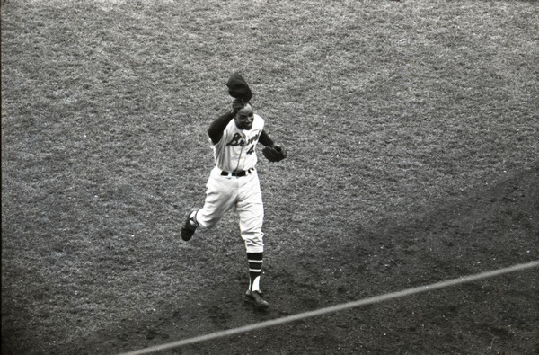 Elevated view of Henry 'Hank' Aaron tipping his cap to the fans during the Braves' final game of the 1964 season.
