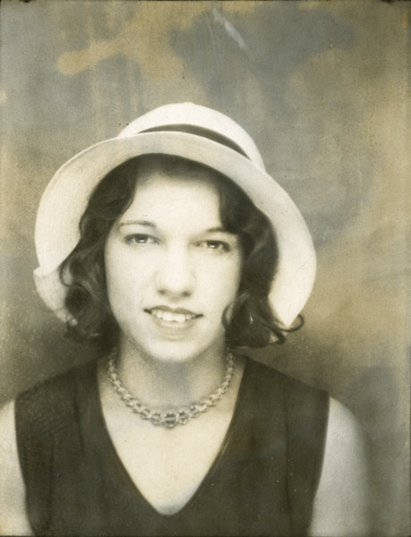 Quarter-length portrait of Alice Klusinski wearing a light-colored hat and a necklace.