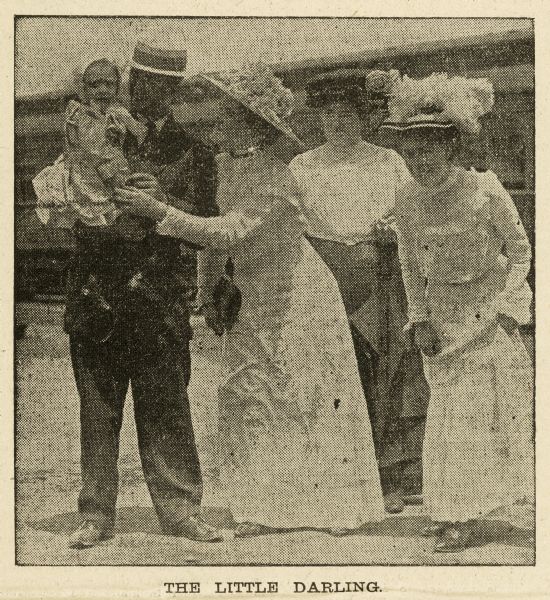 Newspaper clipping titled: "The Little Darling" shows a couple holding an orphan train child as two other women look on.