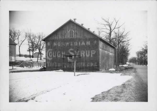 An advertisement for Norwegian cough syrup painted on the side of a barn near Stoughton on Highway N.