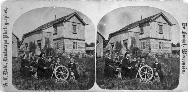 The extended family of Aslak Olsen Lie posing before the home he built in 1849 with his brother Ole after immigrating in 1848. The house is a combination of Norwegian building tradition and American materials and methods. From left to right are Mrs. Marit Lie Skogen (daughter); Martha Skogen Thompson (Marit's daughter) holding two children; an unidentified man; Ole Olsen Lie (A.O. Lie's older brother, a childless widower); an unidentified man with a hatchet; Aslak Olsen Lie; Marit Kamben Lie (Aslak's wife); and an unidentified child. See Additional Information below for further identifications.