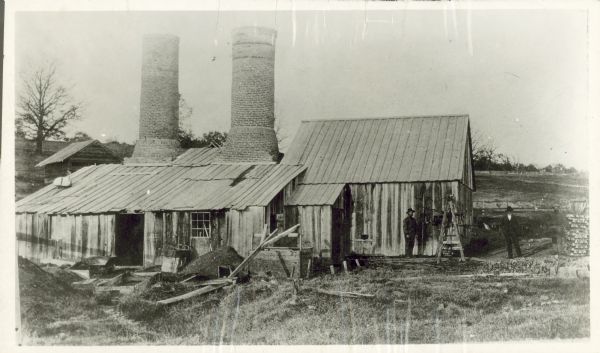 Galena (lead sulfide) was melted at this open hearth furnace owned by Richard Straw and Company on the Roundtree Branch of the Little Platte River. The men are John Johnson, Richard Straw and William Pedelty.