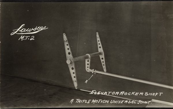Photographic postcard showing the elevator rocker shaft for the Lawson Military Tractor 2 (M.T.2). Additionally, a triple motion universal joint is identified in the image at point A.