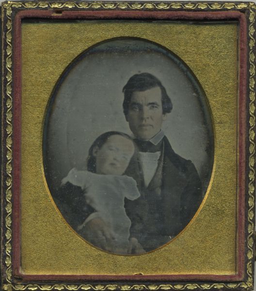 Sixth plate daguerreotype of Increase A. Lapham, facing forward, holding a child (possibly Seneca G. Lapham) with his right arm. The child is leaning his head back on Lapham's right shoulder. 