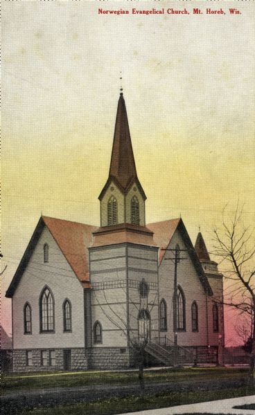 Hand-colored postcard view of the exterior of the Norwegian Evangelical Church. Caption reads: "Norwegian Evangelical Church, Mt. Horeb, Wis."