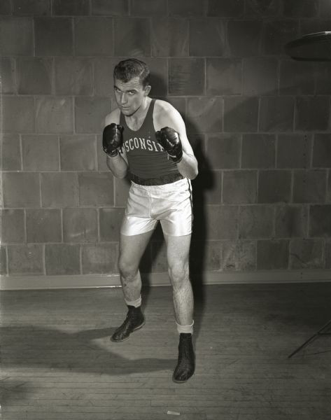 Portrait of Gordon Kowing, one of two University of Wisconsin boxers who met for the heavyweight championship of the sixteenth annual Tournament of Contenders held at the University of Wisconsin fieldhouse. Kowing from Madison faced Gerald Meath of New Richmond.
