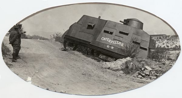 Prototype of a G-9 Caterpillar tank during a demonstration for members of the United States Army at the Los Angeles River. Two men stand on the left.