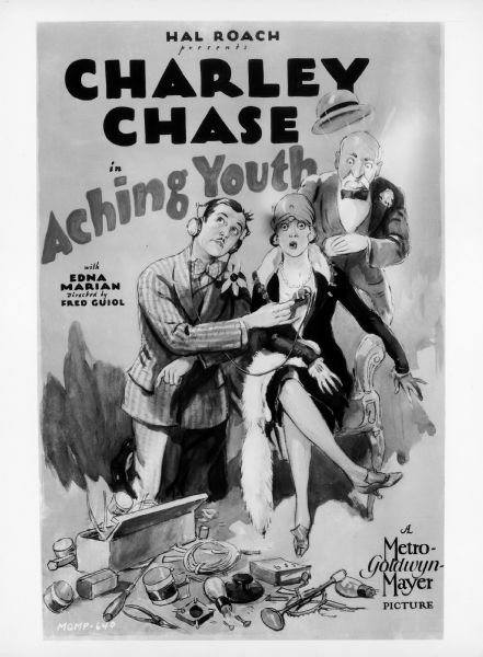Photograph of a poster for the 1928 film <i>Aching Youth</i> starring Charley Chase. Chase kneels next to a seated woman and holds a microphone to her chest. The woman and an older man standing behind her both have surprised looks on their faces.