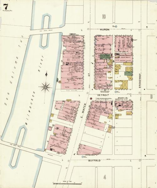 Sanborn map of Milwaukee, with the Milwaukee River on the left, and Water Street in the center. There are two iron draw bridges over the river.