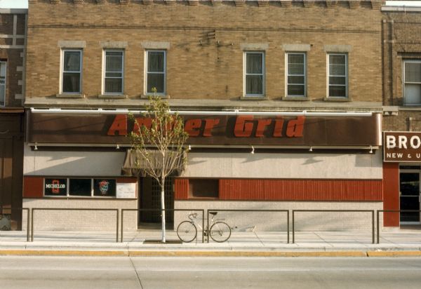 Exterior view of the Amber Grid at 1313 University Avenue. There is a bicycle parked in front of the building.