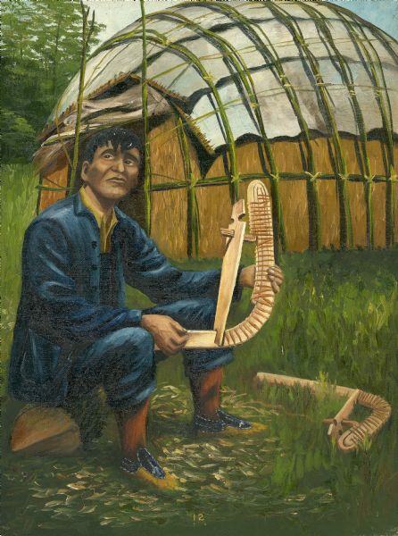An Ojibwa man shows a completed bow or stem for a canoe that he's constructing. Behind the man is a wigwam (or wetu).