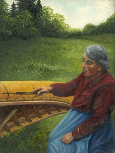 An Ojibwa woman caulks the seams of a canoe with pitch.