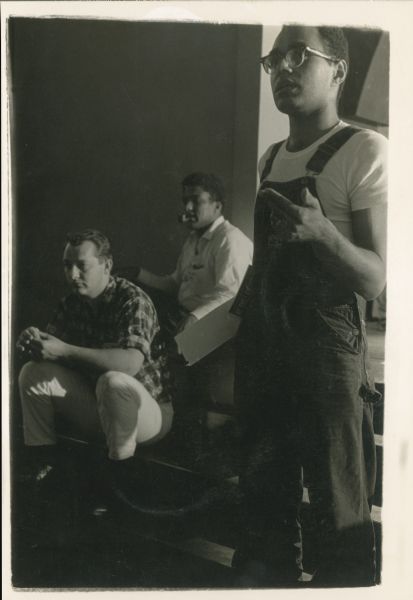 Bob (Robert) Moses stands on the far right, speaking. On the far left is Bob Zellner, SNCC (Student Nonviolent Coordinating Committee) Field Secretary, and the man in the middle in the white shirt is James Forman.  Moses, a noted civil rights leader, was the lead organizer of the Freedom Summer project.