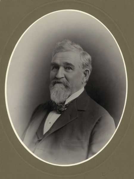 Quarter-length oval-framed portrait of Edwin Bryant with a white beard and hair.