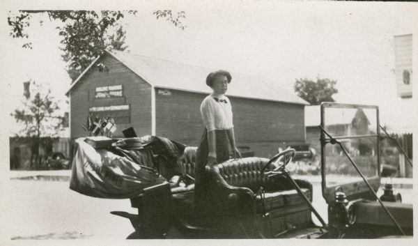 Maud McCreery speaking from the back seat of a car during a Women's Suffrage in Wisconsin Campaign. Mrs. McCreery was a women's suffrage activist who worked as a county organizer for the Political Equality League.