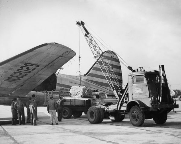 Motor being loaded onto an airplane.